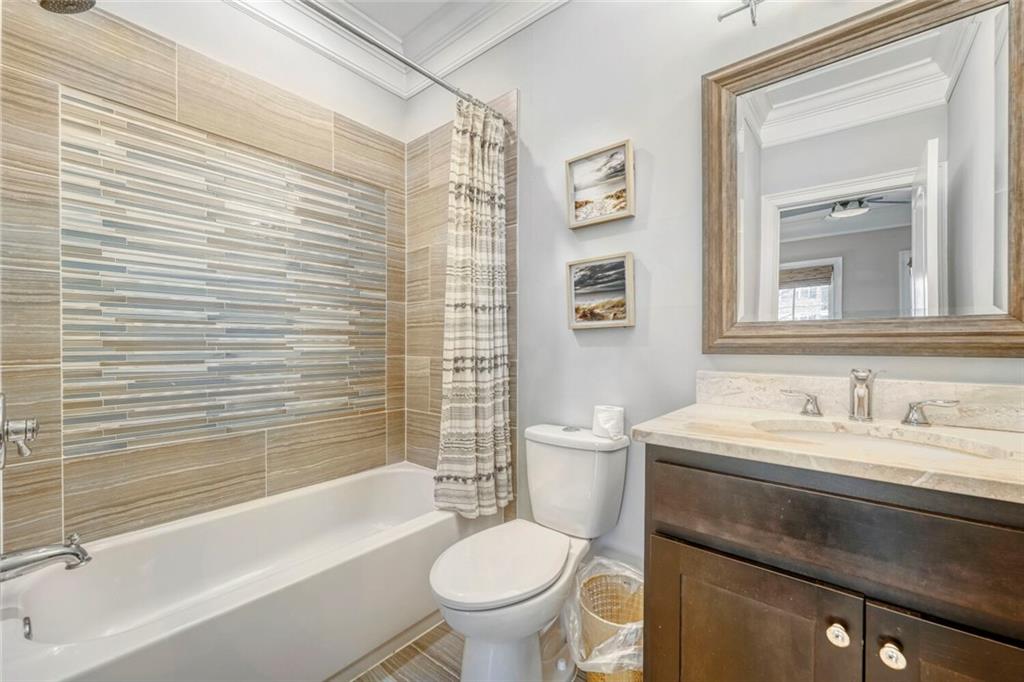 1196 John Collier Road Northwest, Unit 1196 Atlanta, GA 30318 - Photo 24 of 26 a bathroom with a sink a toilet and a bathtub
