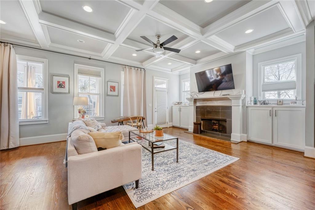 1196 John Collier Road Northwest, Unit 1196 Atlanta, GA 30318 - Photo 6 of 26 a living room with furniture a fireplace and a flat screen tv