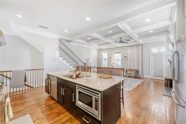 a open kitchen with stainless steel appliances granite countertop a stove and a sink