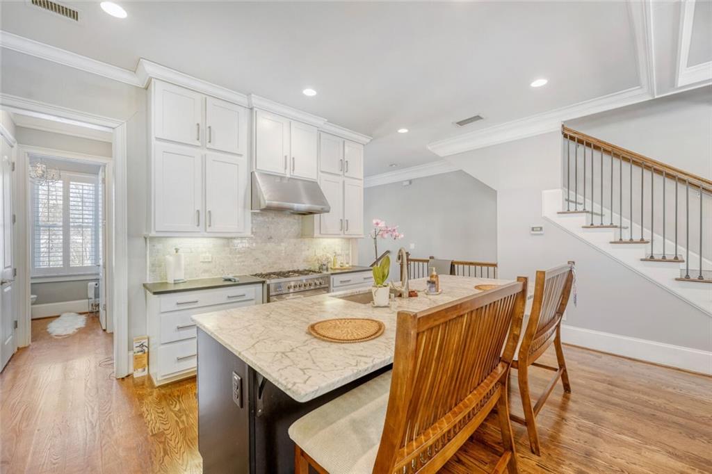 1196 John Collier Road Northwest, Unit 1196 Atlanta, GA 30318 - Photo 10 of 26 a kitchen with a table chairs and wooden floor