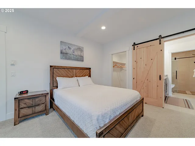 a bedroom with a bed and a view of bathroom