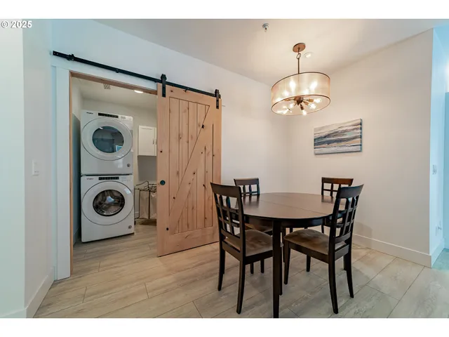a view of a dining room with furniture wooden floor and chandelier
