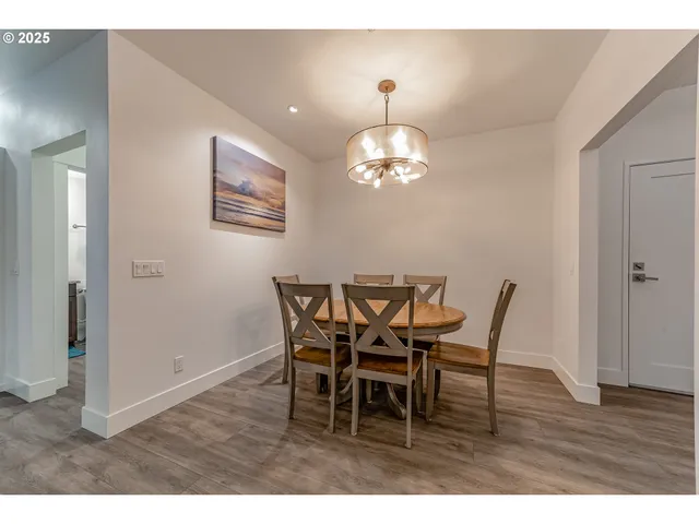a view of a dining room with furniture and wooden floor