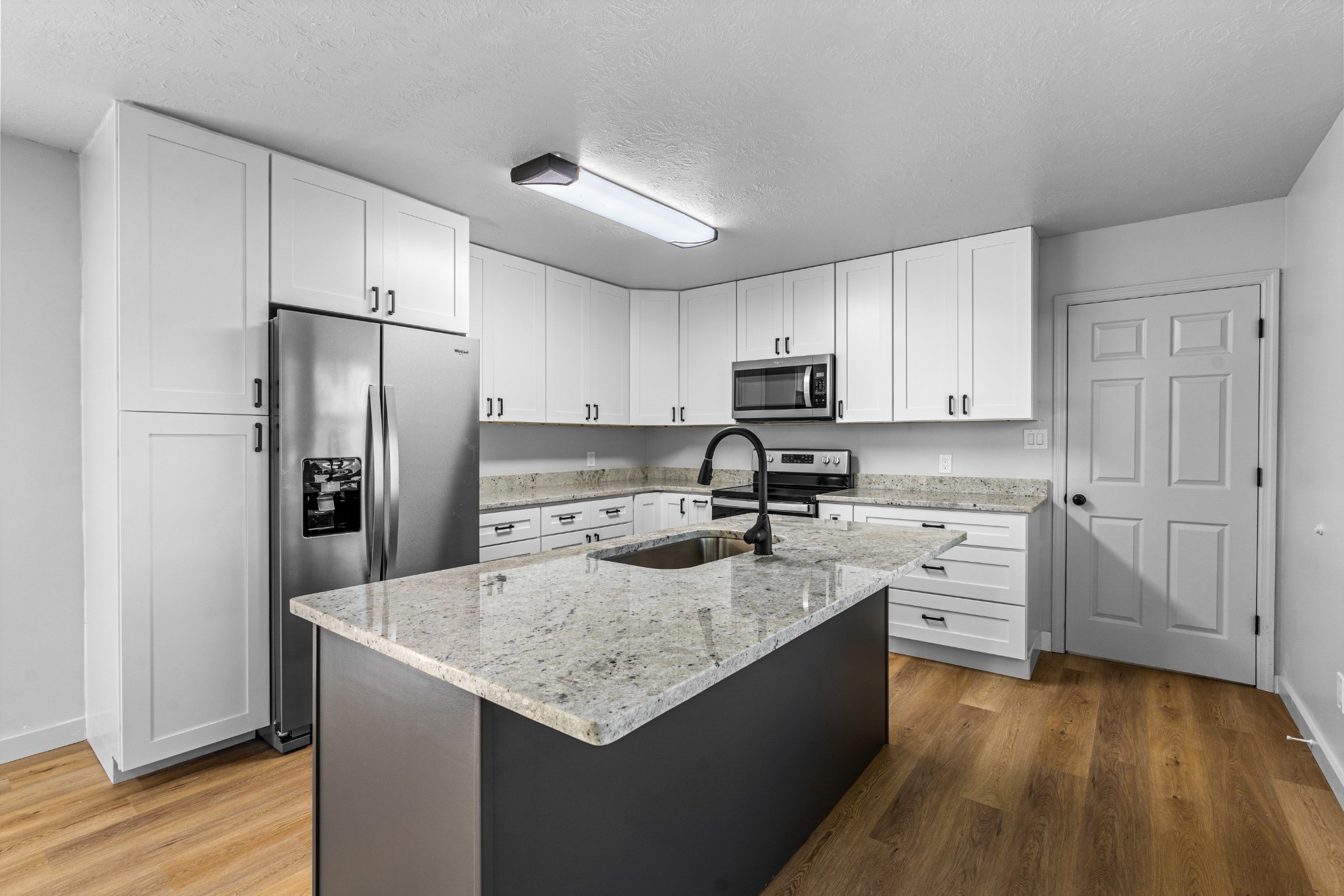 191 Blanton Chapel Road Manchester, TN 37355 - Photo 7 of 26 a kitchen with stainless steel appliances granite countertop a sink stove refrigerator and cabinets