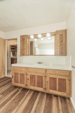 a view of a room with wooden floors and white walls