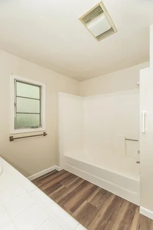 a view of an empty room and wooden floor
