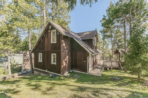 a view of a yard with large trees