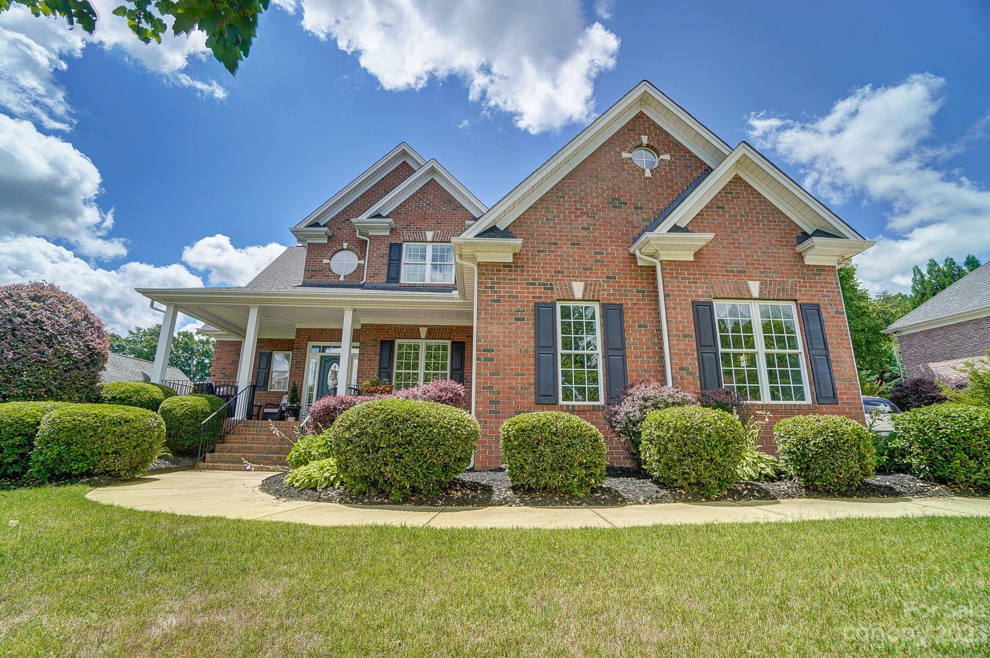 1105 Legacy Lane Fort Mill, SC 29708 - Photo 1 of 43 a front view of a house with a yard