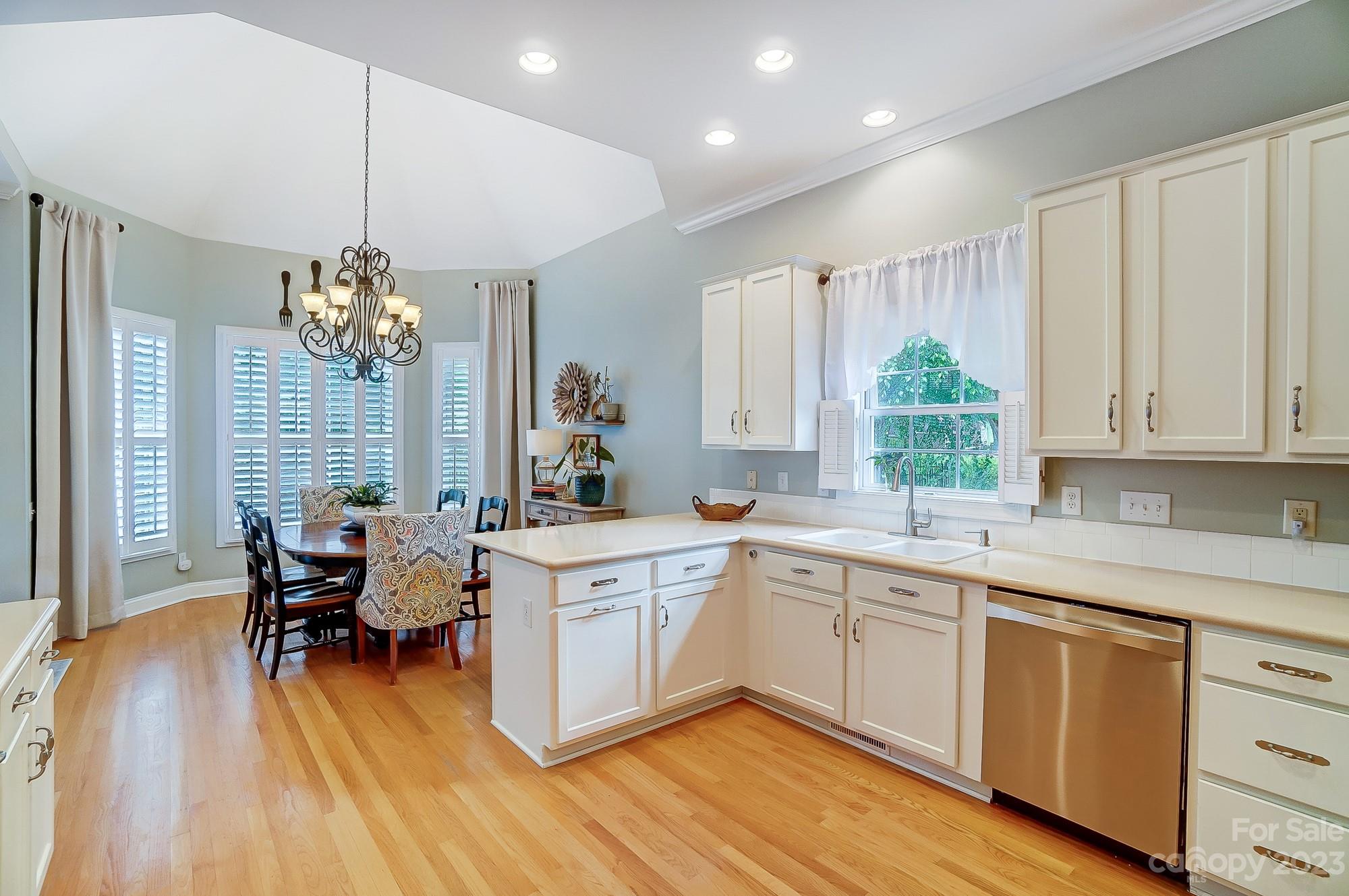 1105 Legacy Lane Fort Mill, SC 29708 - Photo 11 of 43 a kitchen with a dining table chairs sink and granite counter tops
