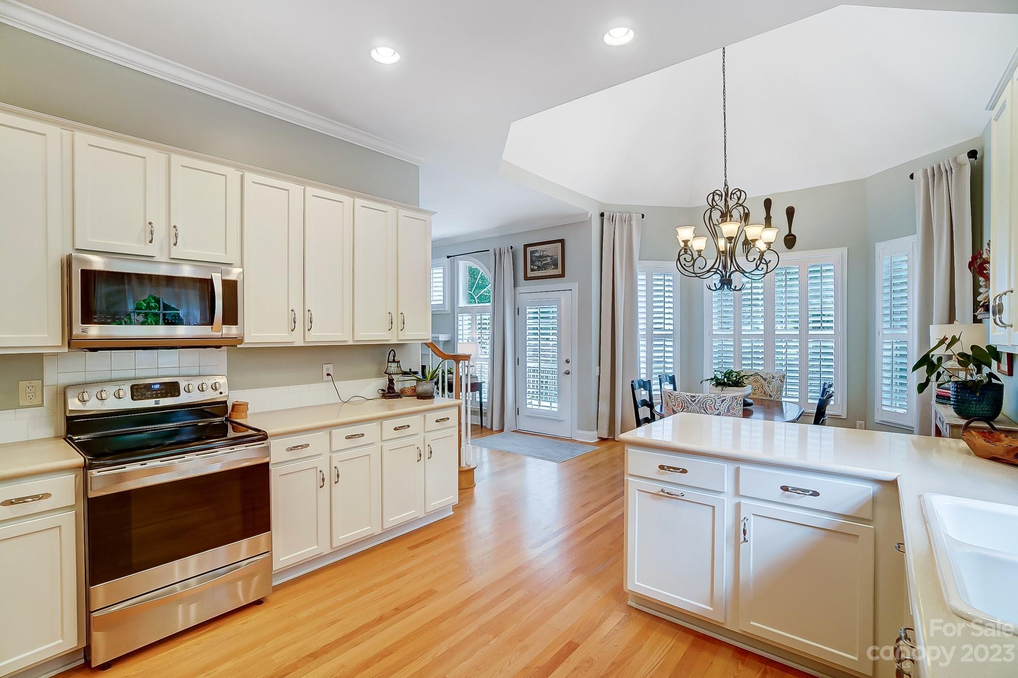 1105 Legacy Lane Fort Mill, SC 29708 - Photo 13 of 43 a open kitchen with stainless steel appliances a white stove top oven and cabinets