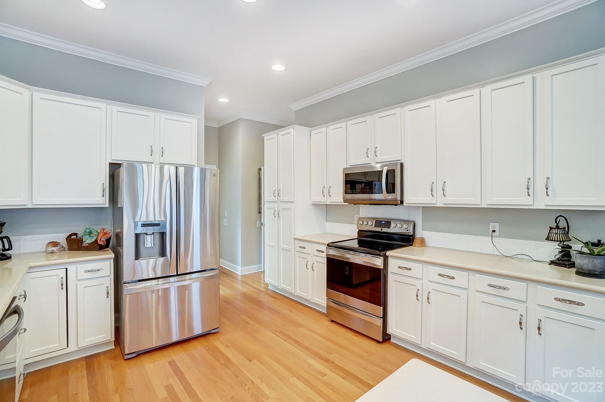 1105 Legacy Lane Fort Mill, SC 29708 - Photo 14 of 43 a kitchen with stainless steel appliances granite countertop a refrigerator stove a sink and white cabinets