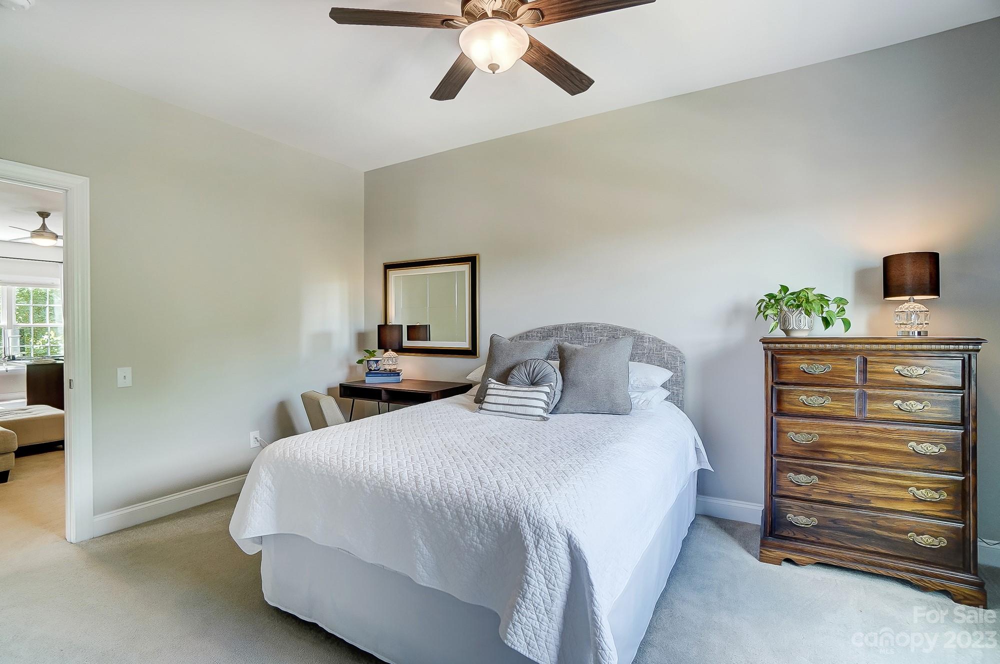 1105 Legacy Lane Fort Mill, SC 29708 - Photo 29 of 43 a bedroom with a bed and a chandelier