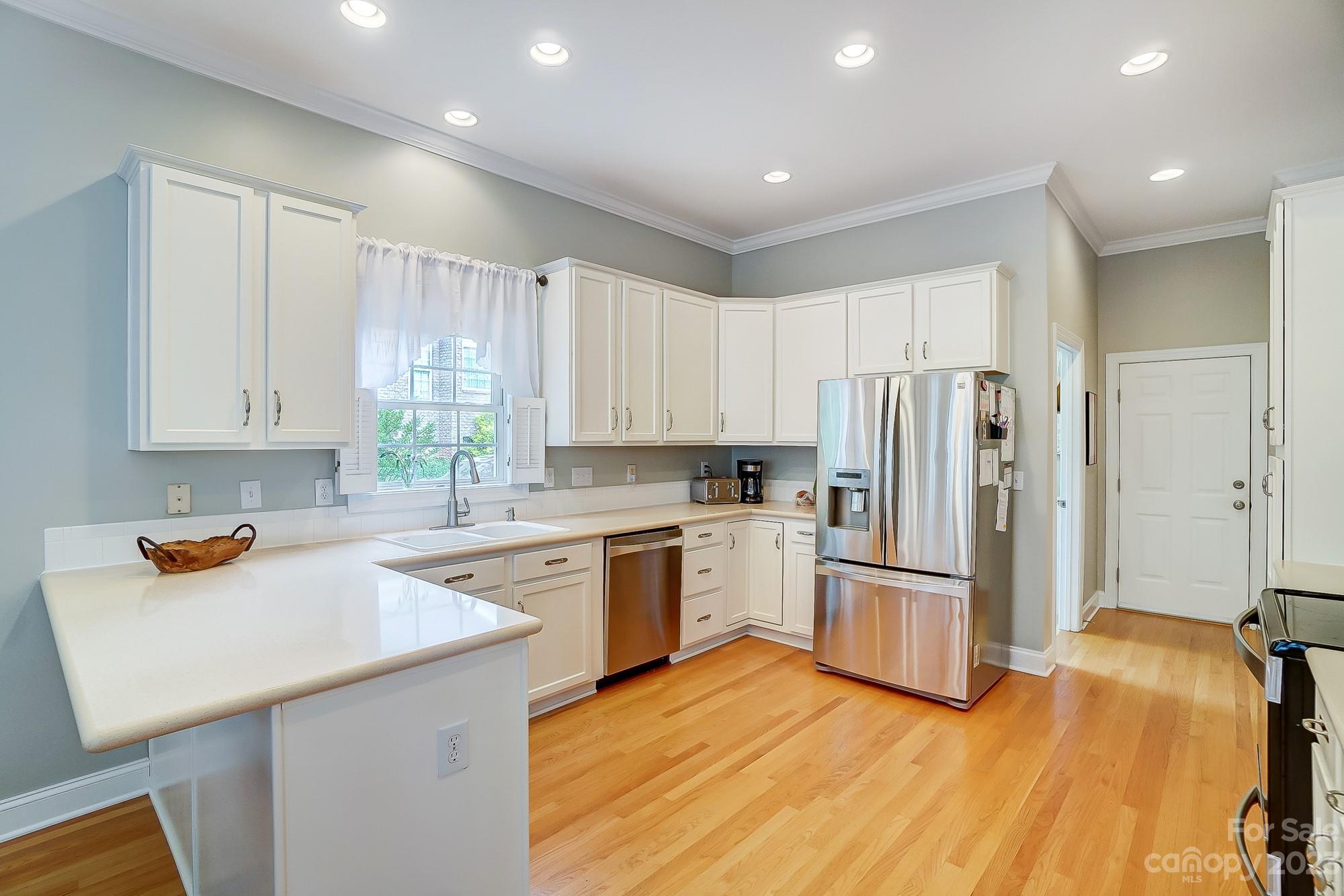 1105 Legacy Lane Fort Mill, SC 29708 - Photo 9 of 43 a kitchen with a sink a refrigerator and window