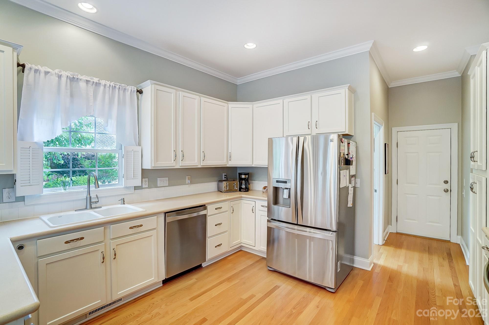 1105 Legacy Lane Fort Mill, SC 29708 - Photo 10 of 43 a kitchen with a white cabinets and wooden floor