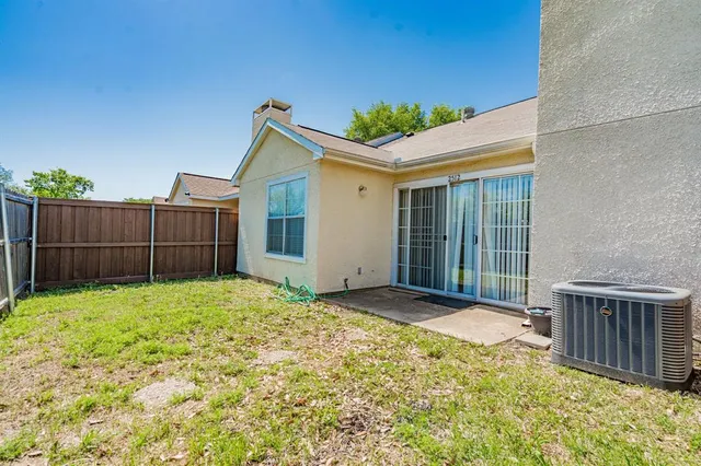 a view of backyard with small cabin and wooden fence