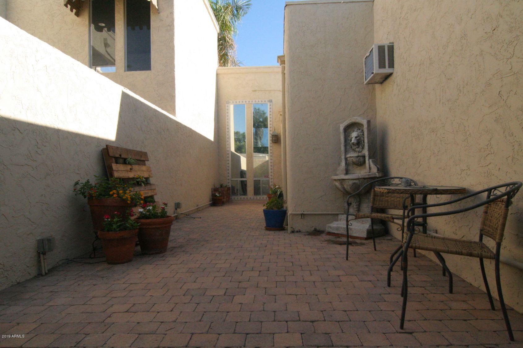 136 West Victoria Square Phoenix, AZ 85013 - Photo 2 of 15 a view of a patio with chairs and a potted plant