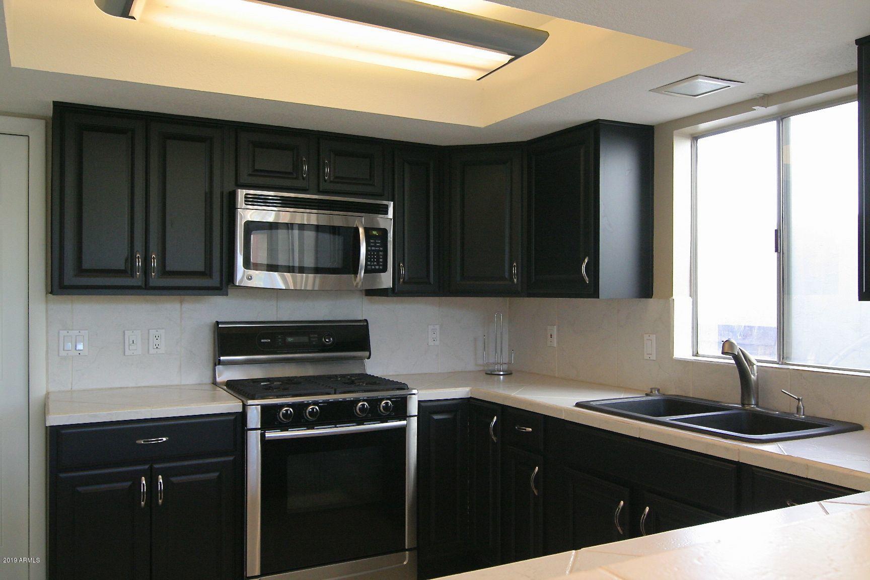 136 West Victoria Square Phoenix, AZ 85013 - Photo 3 of 15 a kitchen with a sink and steel appliances