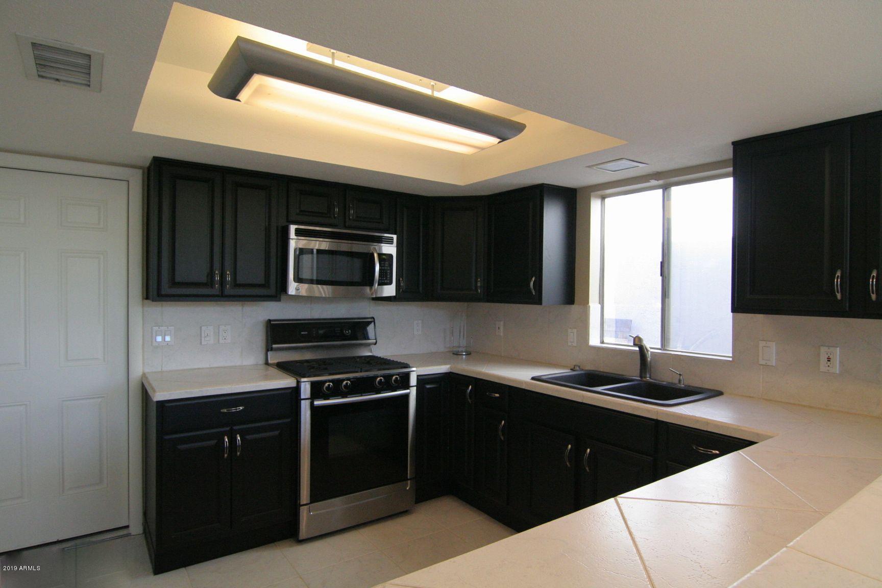 136 West Victoria Square Phoenix, AZ 85013 - Photo 5 of 15 a kitchen with a sink a stove and microwave
