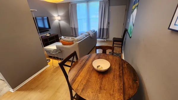 a view of a dining room with furniture and wooden floor