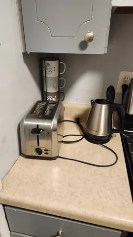 a bedroom with a bed and a lamp on table
