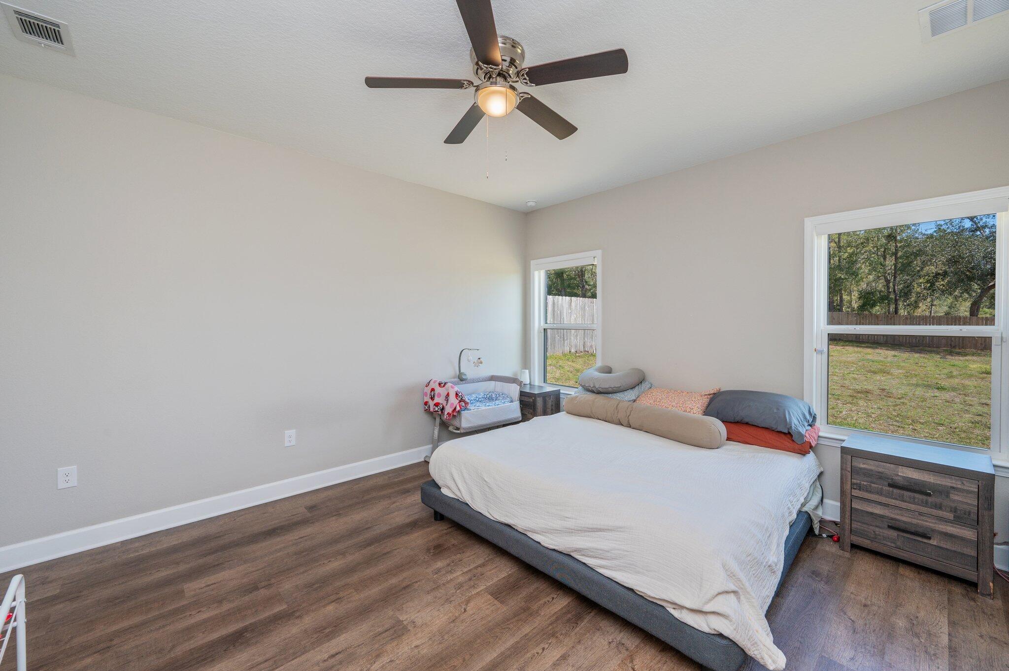 5179 Rabbit Run Crestview, FL 32539 - Photo 11 of 30 a bedroom with a bed chandelier and a window