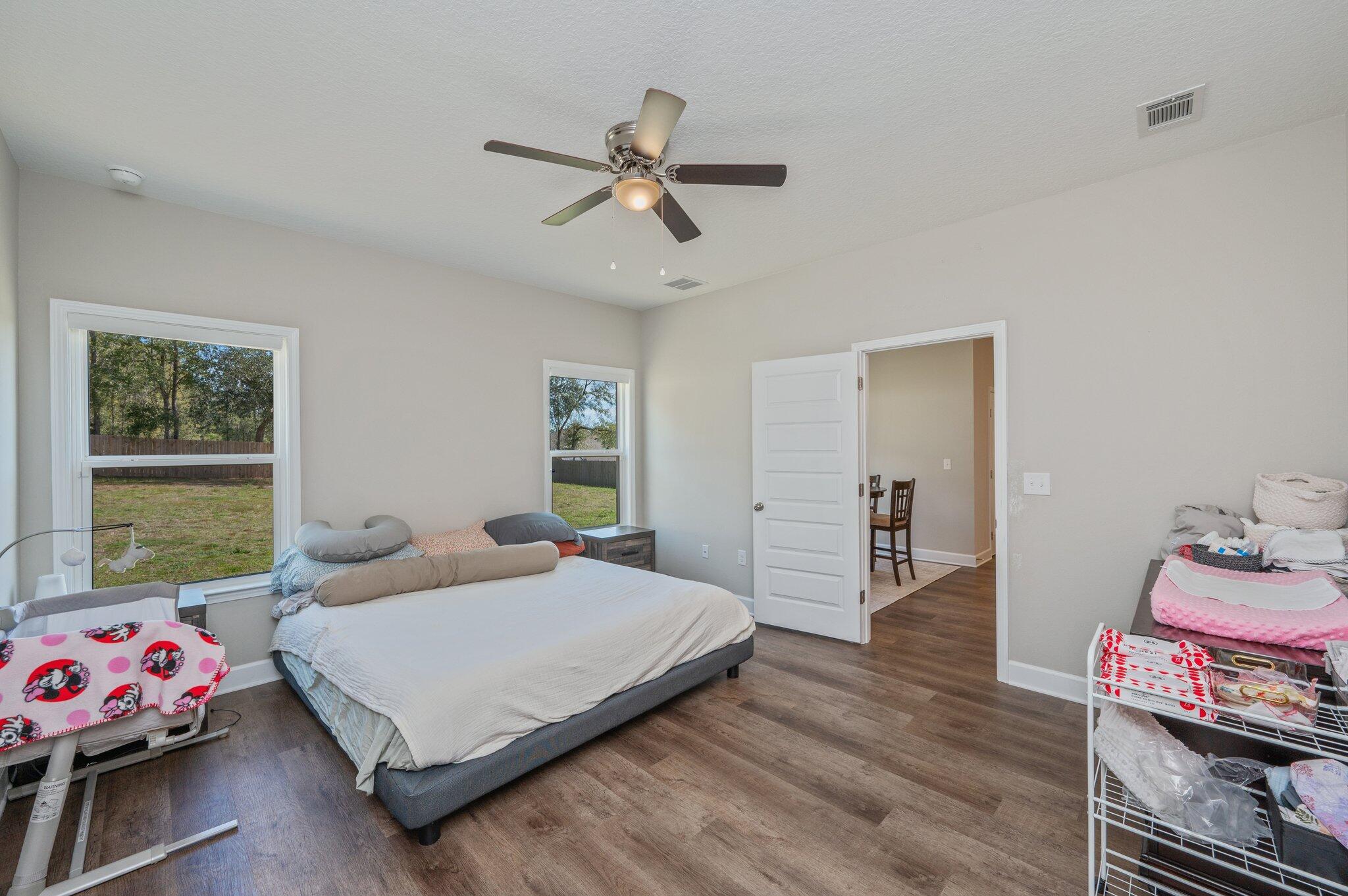 5179 Rabbit Run Crestview, FL 32539 - Photo 12 of 30 a bedroom with a bed and wooden floor