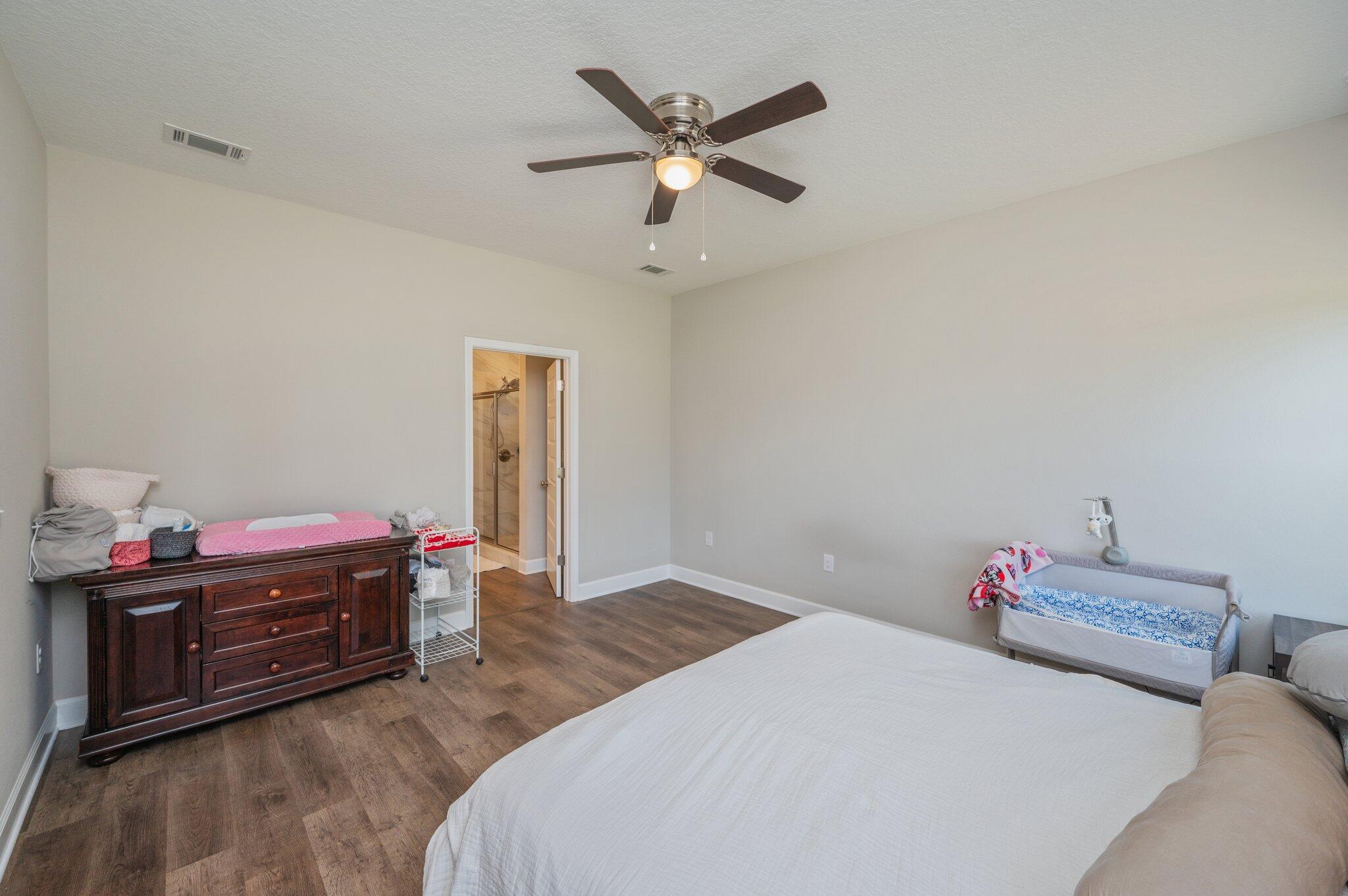 5179 Rabbit Run Crestview, FL 32539 - Photo 13 of 30 a bedroom with a bed and a chandelier