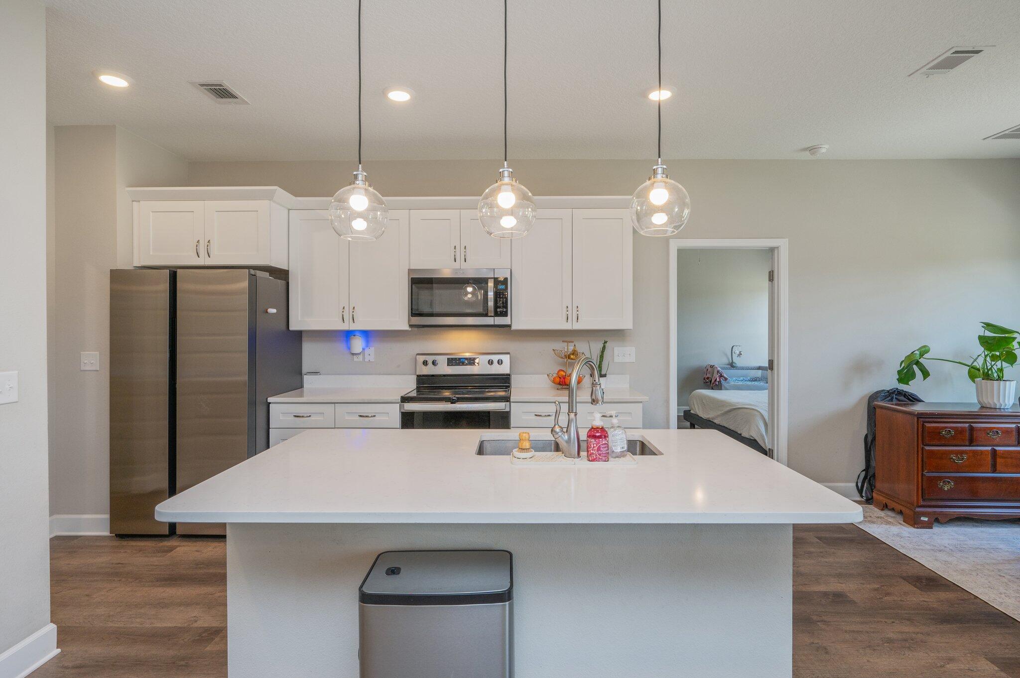 5179 Rabbit Run Crestview, FL 32539 - Photo 5 of 30 a kitchen with kitchen island a sink stainless steel appliances and wooden floor