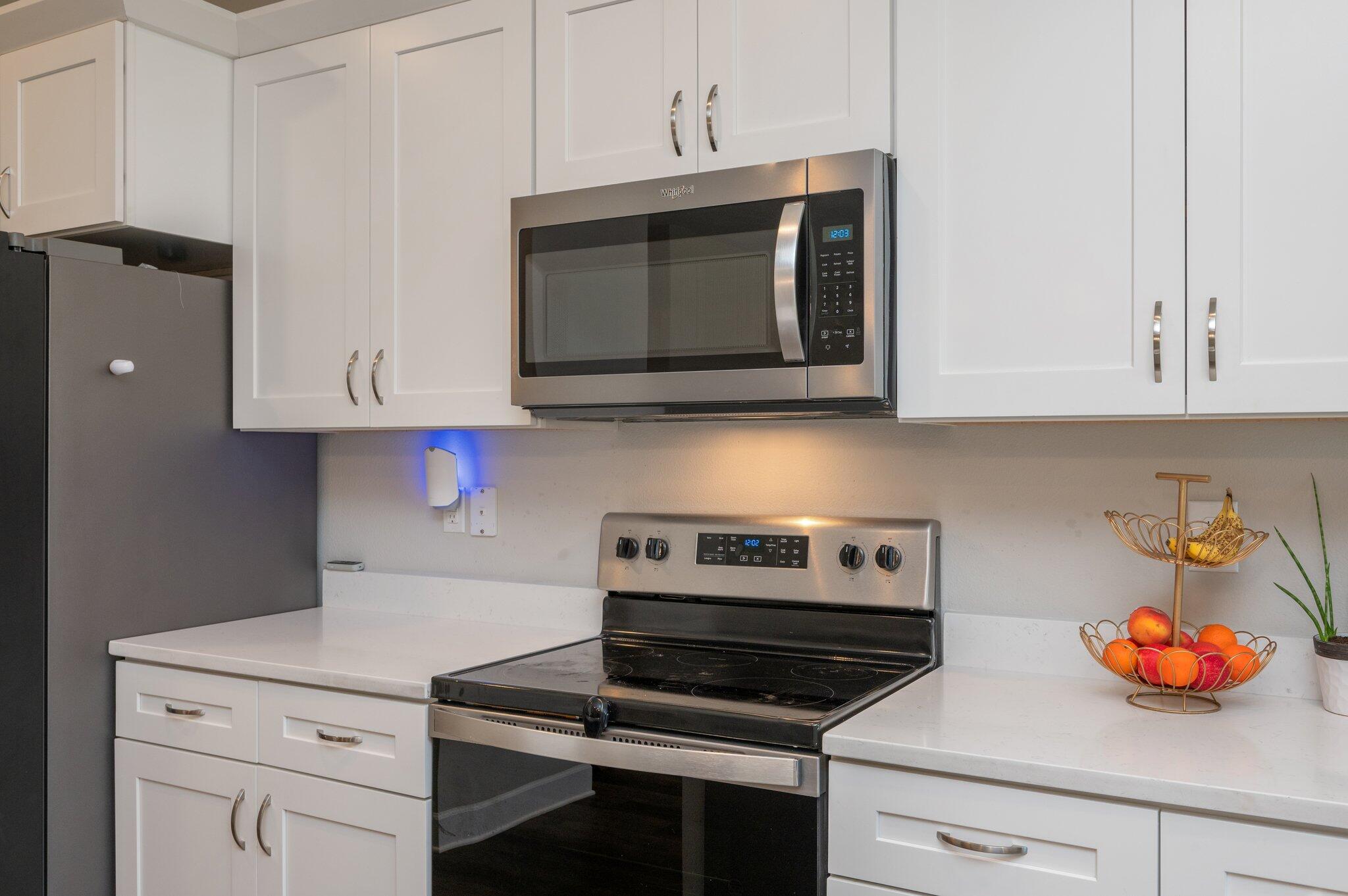 5179 Rabbit Run Crestview, FL 32539 - Photo 8 of 30 a kitchen with stainless steel appliances granite countertop white cabinets and a stove top oven