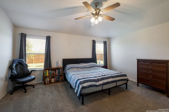 a bedroom with a bed chair and a window