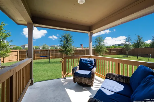 a view of a porch with furniture and a yard