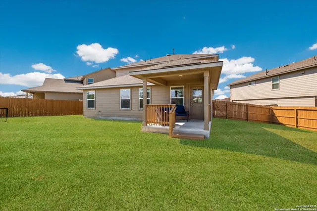 a view of a house with a backyard