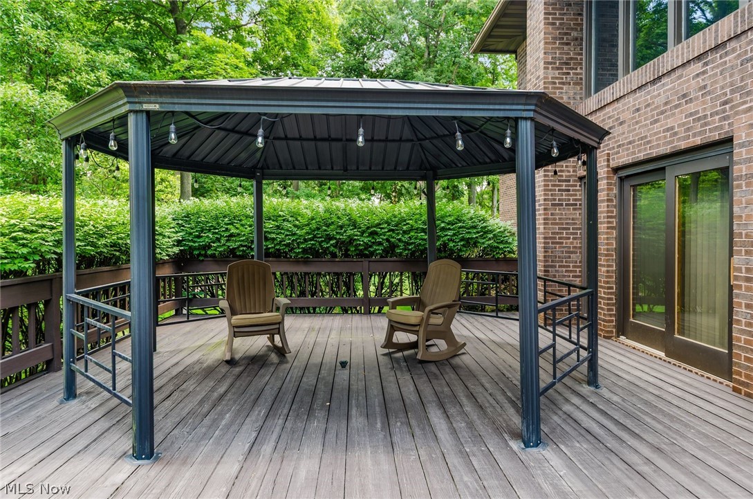 200 Hampshire Road Akron, OH 44313 - Photo 44 of 50 Expansive outdoor deck featuring a metal gazebo with string lighting, wood deck flooring, and a brick exterior facade