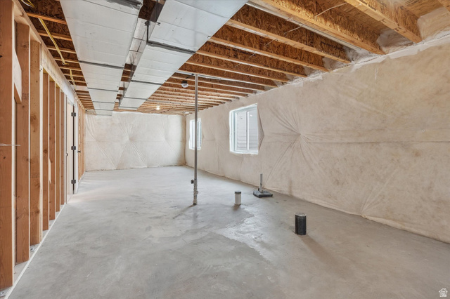 730 West 500 North Smithfield, UT 84335 - Photo 23 of 46 Unfinished basement space with exposed wooden joists, concrete flooring, two windows, and visible ductwork