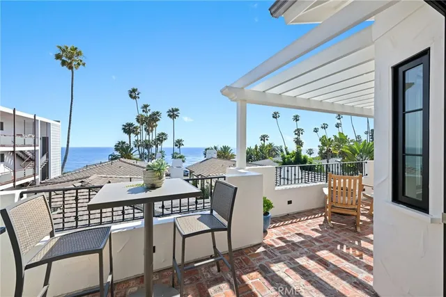 a kitchen with stainless steel appliances a stove a chimney a sink and cabinets