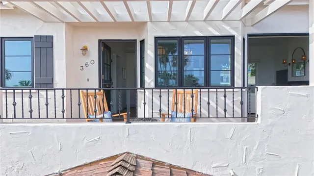 a vase of flowers sitting on a table with a potted plant
