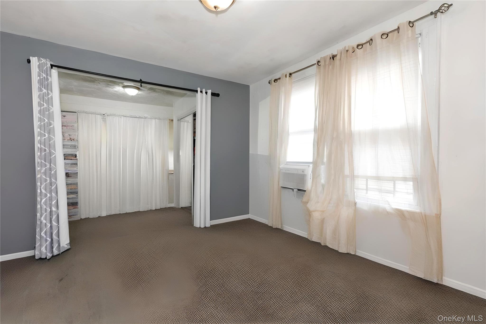 37-33 100th Street Queens, NY 11368 - Photo 8 of 14 Unfurnished bedroom with carpet floors and baseboards