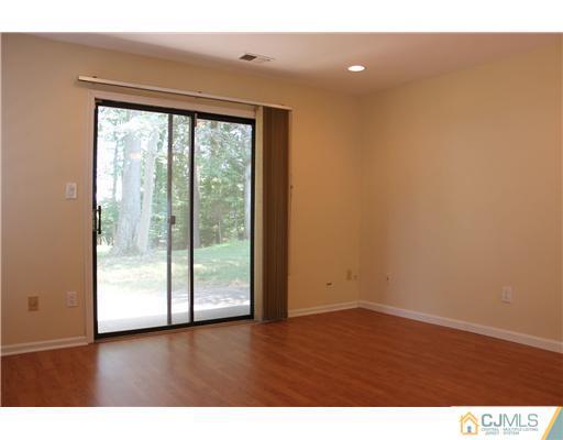 2001 Timber Oaks Road Edison, NJ 08820 - Photo 11 of 25 a view of an empty room with wooden floor and a window