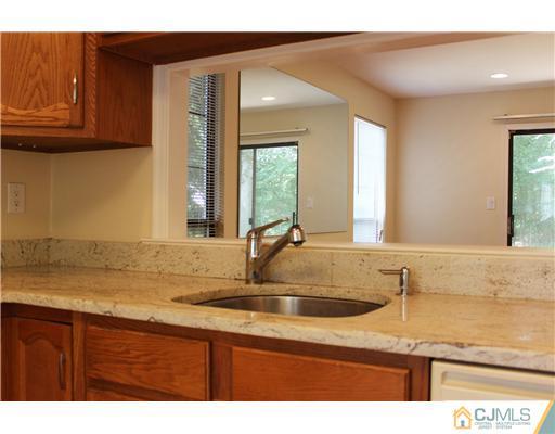 2001 Timber Oaks Road Edison, NJ 08820 - Photo 12 of 25 a view of a kitchen with kitchen island a sink wooden floor and a large window