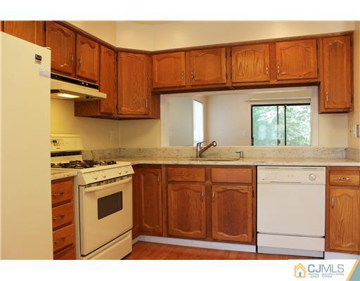 2001 Timber Oaks Road Edison, NJ 08820 - Photo 15 of 25 a kitchen with stainless steel appliances granite countertop a stove a sink and a microwave
