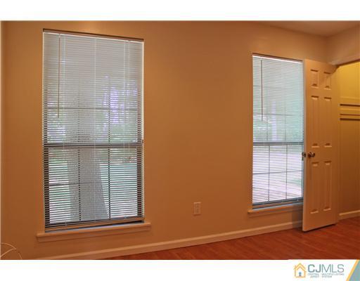 2001 Timber Oaks Road Edison, NJ 08820 - Photo 17 of 25 a view of wooden floor and windows in a room