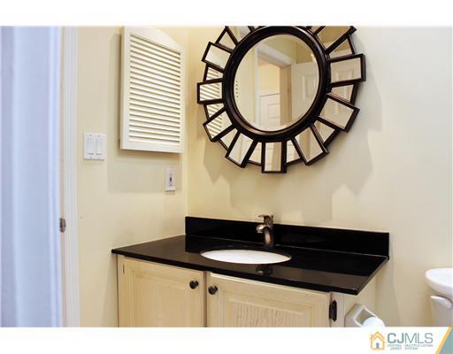 2001 Timber Oaks Road Edison, NJ 08820 - Photo 20 of 25 a bathroom with a sink a mirror and a window