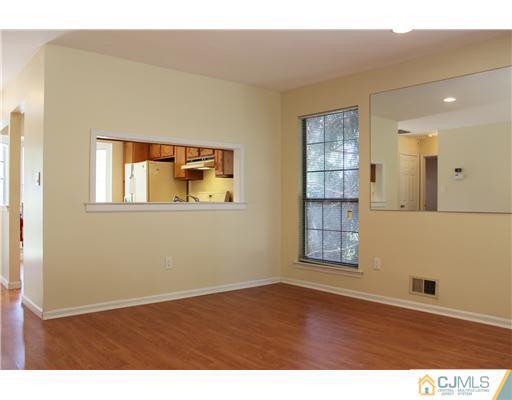 2001 Timber Oaks Road Edison, NJ 08820 - Photo 3 of 25 a view of an empty room with wooden floor and a window