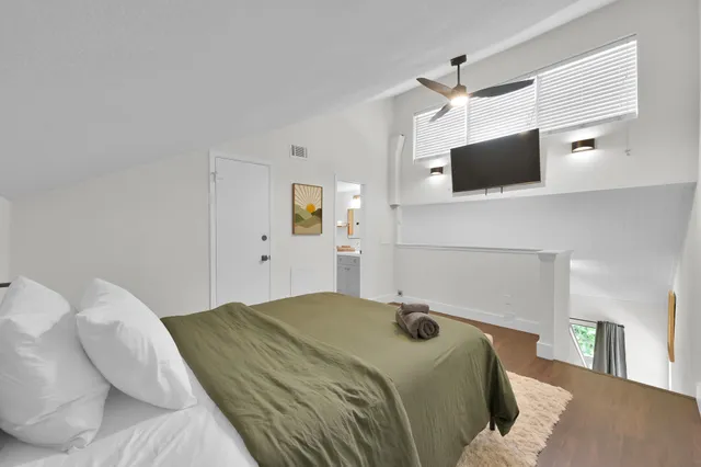 a bedroom with a bed and a television