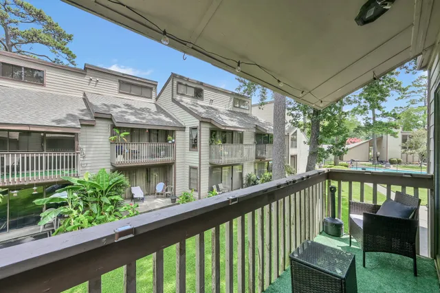 a view of a brick house with large windows and a table
