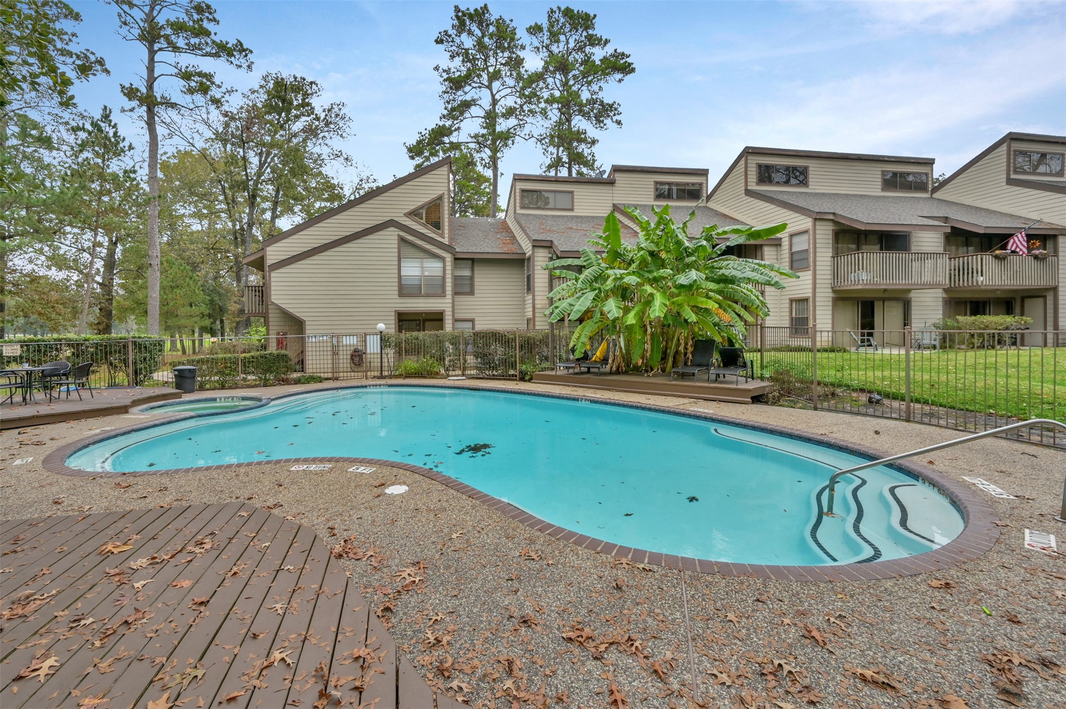 12900 Walden Road, Unit 506E Montgomery, TX 77356 - Photo 21 of 31 a view of a white house with a yard patio and a fountain