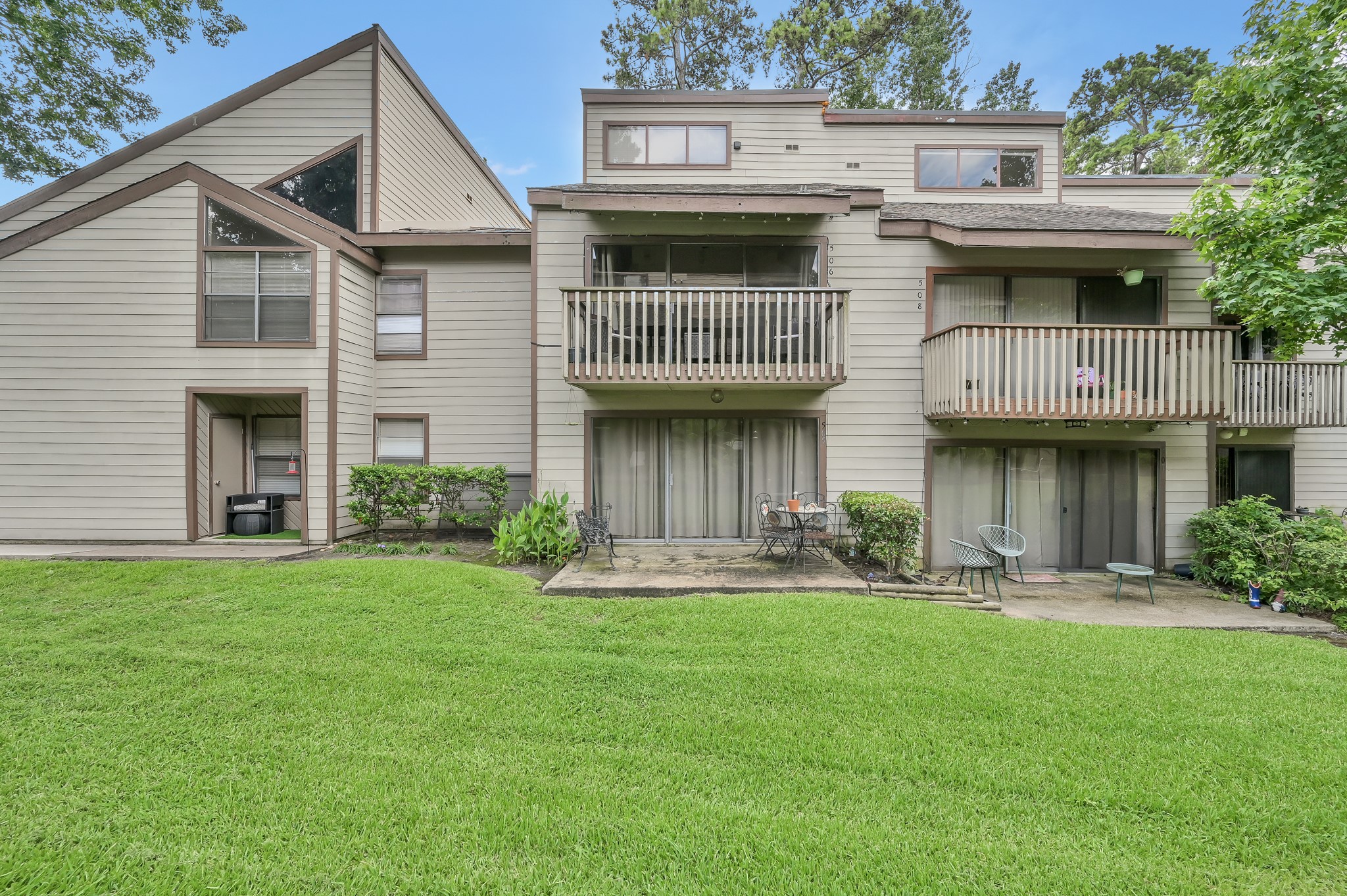 12900 Walden Road, Unit 506E Montgomery, TX 77356 - Photo 31 of 31 a front view of a house with a garden and plants