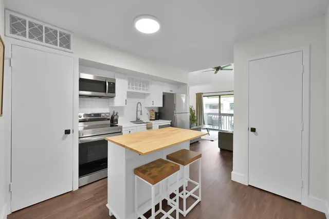 a kitchen with a stove a refrigerator and a refrigerator