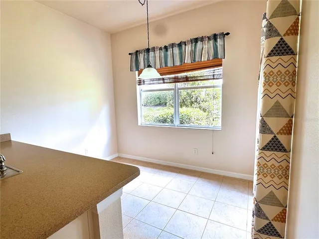 a kitchen with granite countertop a refrigerator stove and microwave