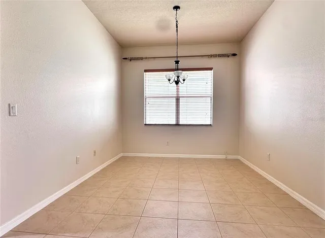 a view of a kitchen with a refrigerator and a window